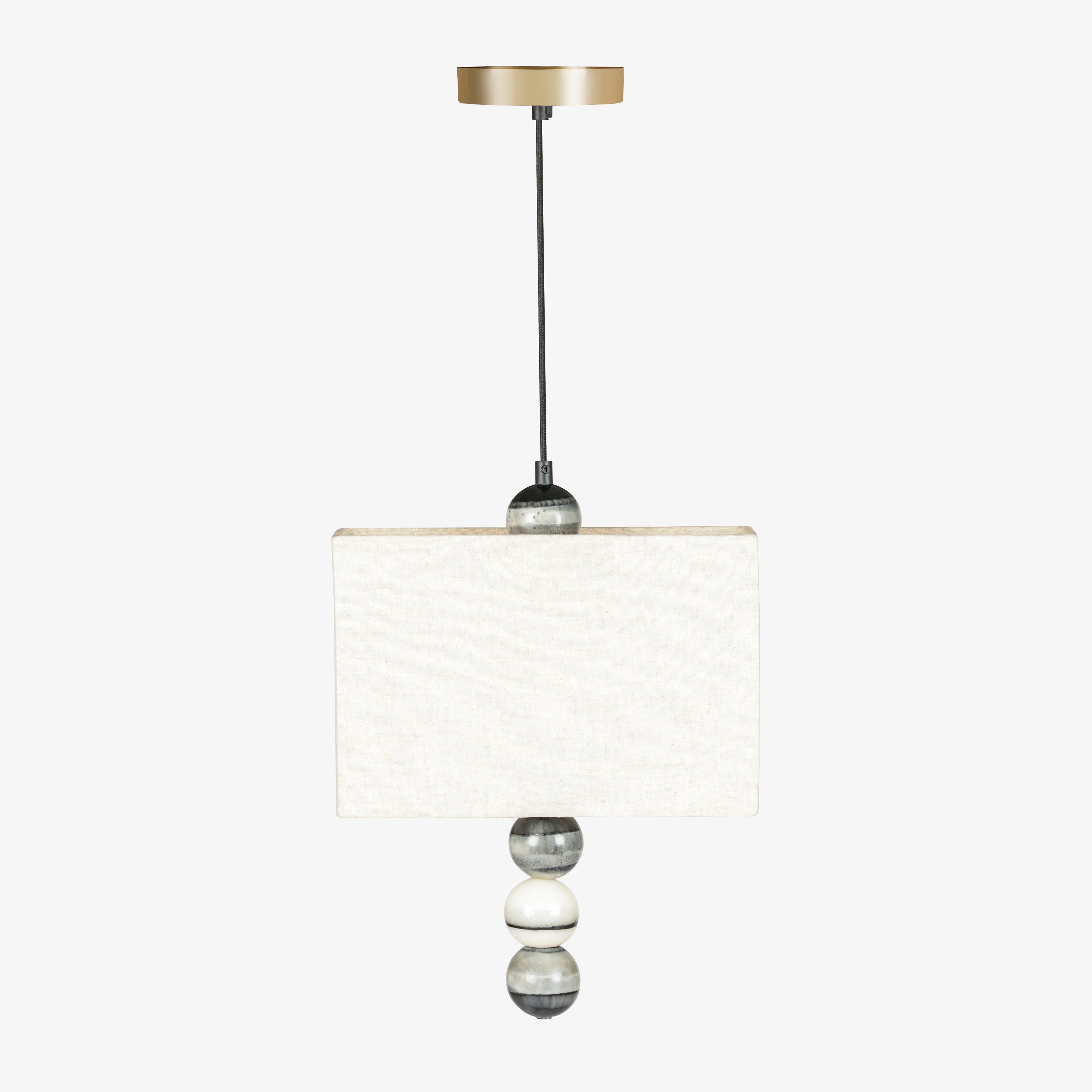Modern pendant light with rectangular fabric shade and marble bead accents, designer hanging lamp for home lighting.
