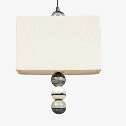 Close-up of linen fabric lampshade on pendant light, premium textured shade for interior lighting.