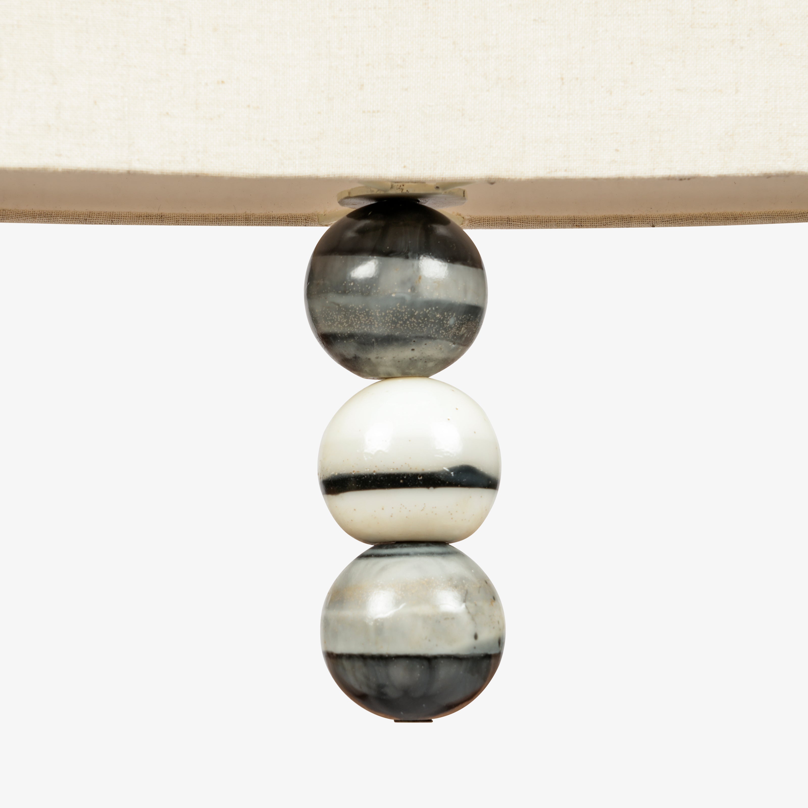 Close-up of marble bead detailing beneath fabric pendant lamp shade, luxury hanging light with stone accents.