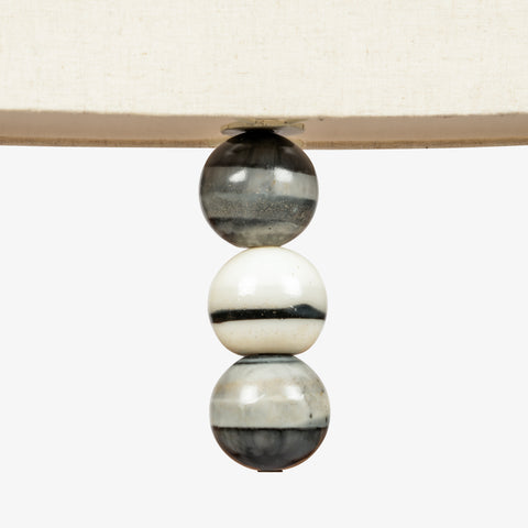 Close-up of marble bead detailing beneath fabric pendant lamp shade, luxury hanging light with stone accents.