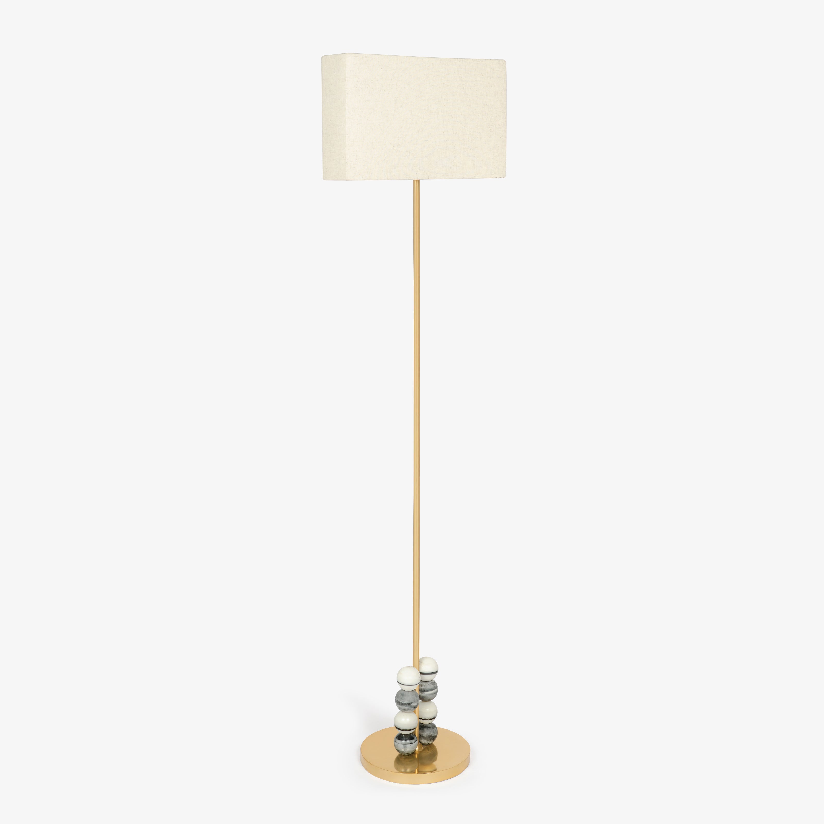 Modern brass floor lamp with rectangular fabric shade and marble bead detailing.
