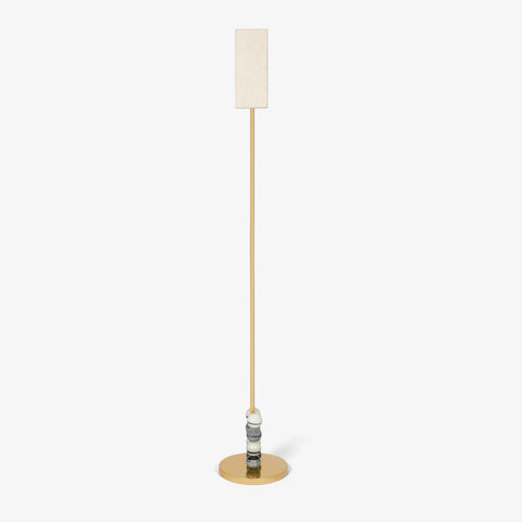 Slim brass floor lamp showing side profile with marble bead base.