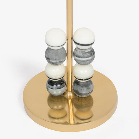 Brass floor lamp base with stacked marble beads detail.