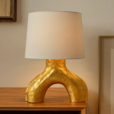 Gold study table lamp with two frosted globes styled as a side table lamp on a wooden sideboard.