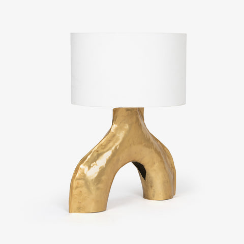 Side profile of a gold bedside lamps structure with a single glowing globe.