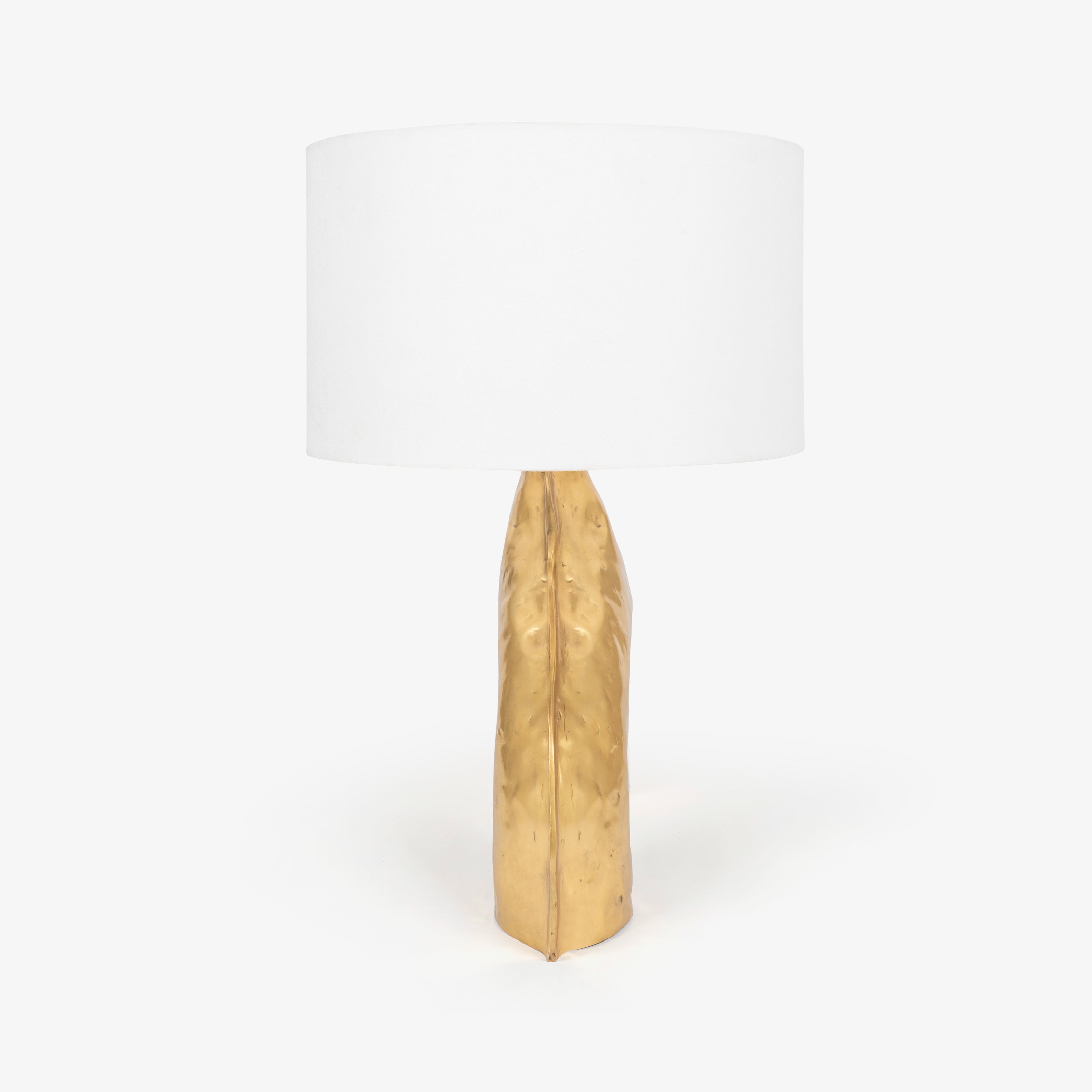 Side profile of a gold bedside lamps structure with a single glowing globe.