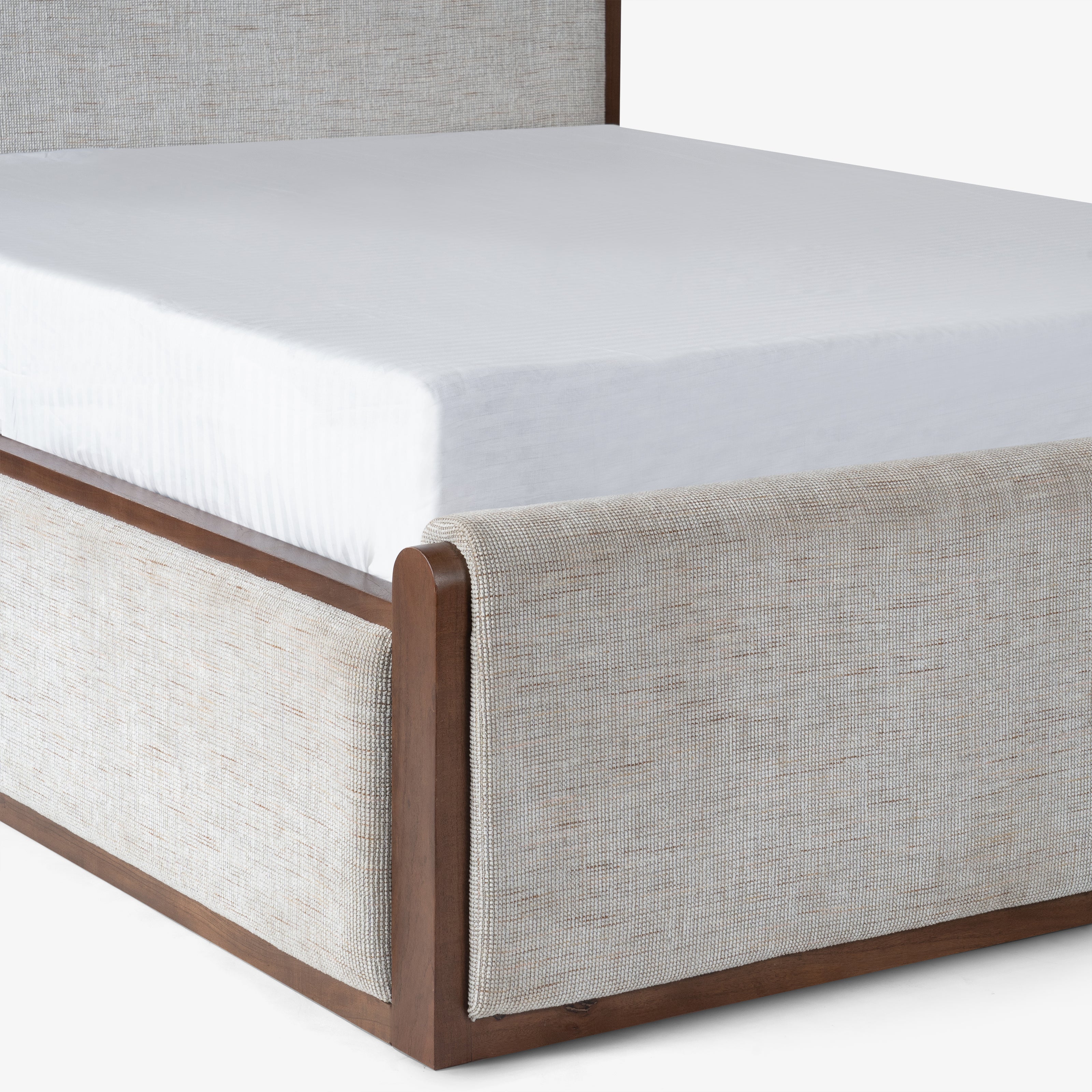 Mattress on beige upholstered bed frame