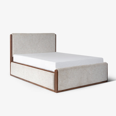 Beige upholstered platform bed, angled view