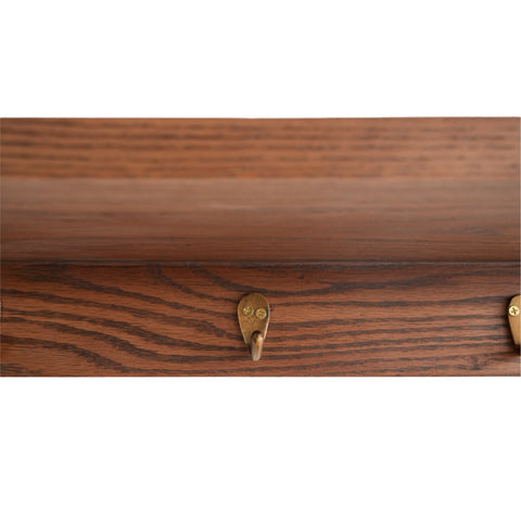 Close-up of the Kanso Ledge Shelf wooden edge and integrated brass hooks