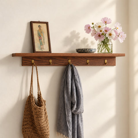 Kanso Ledge Shelf, a wooden wall shelf with hooks styled with books, flowers and everyday accessories