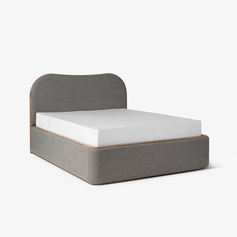 Gray upholstered platform bed, angled view
