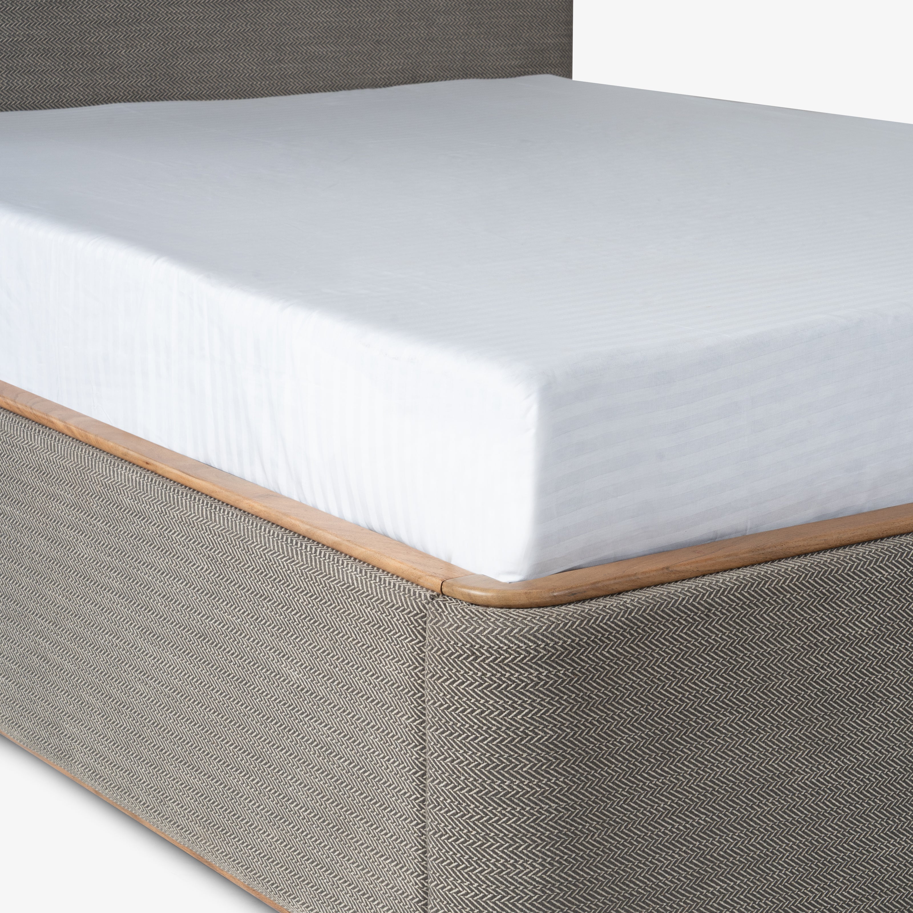 Close-up of gray upholstered bed base