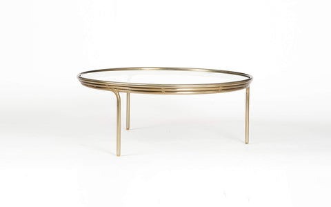 Olivia Glass Top Coffee Table with a brass finish on a mild steel frame. Sleek, modern coffee table is perfect for contemporary living rooms.