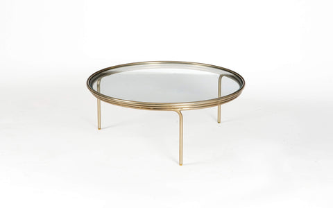 Olivia Glass Top Coffee Table with a brass finish on a mild steel frame. Sleek, modern coffee table is perfect for contemporary living rooms.