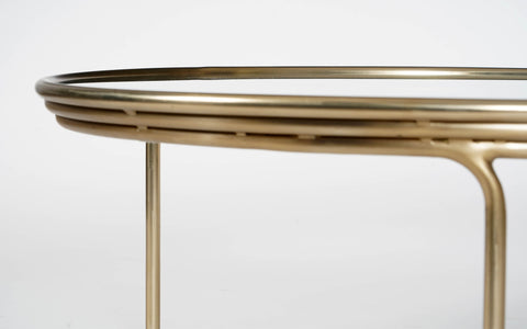 Olivia Glass Top Coffee Table with a brass finish on a mild steel frame. Sleek, modern coffee table is perfect for contemporary living rooms.
