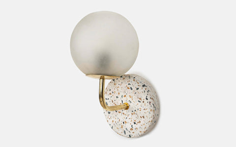 Eros White Wall Lamp with Terrazzo base, Gold-finished Mild Steel, and Frosted Glass shade.  This lamp is available online in India.