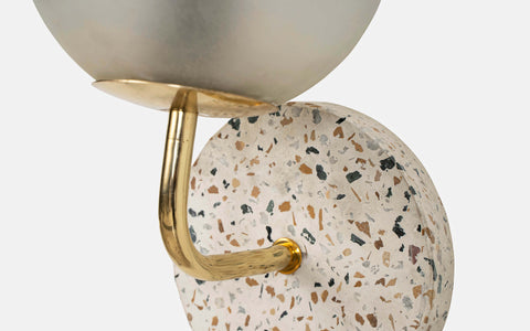 Eros White Wall Lamp with Terrazzo base, Gold-finished Mild Steel, and Frosted Glass shade.  This lamp is available online in India.