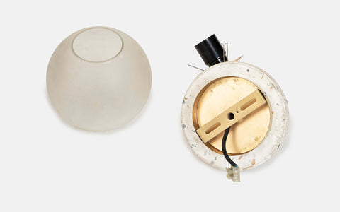 Eros White Wall Lamp with Terrazzo base, Gold-finished Mild Steel, and Frosted Glass shade.  This lamp is available online in India.